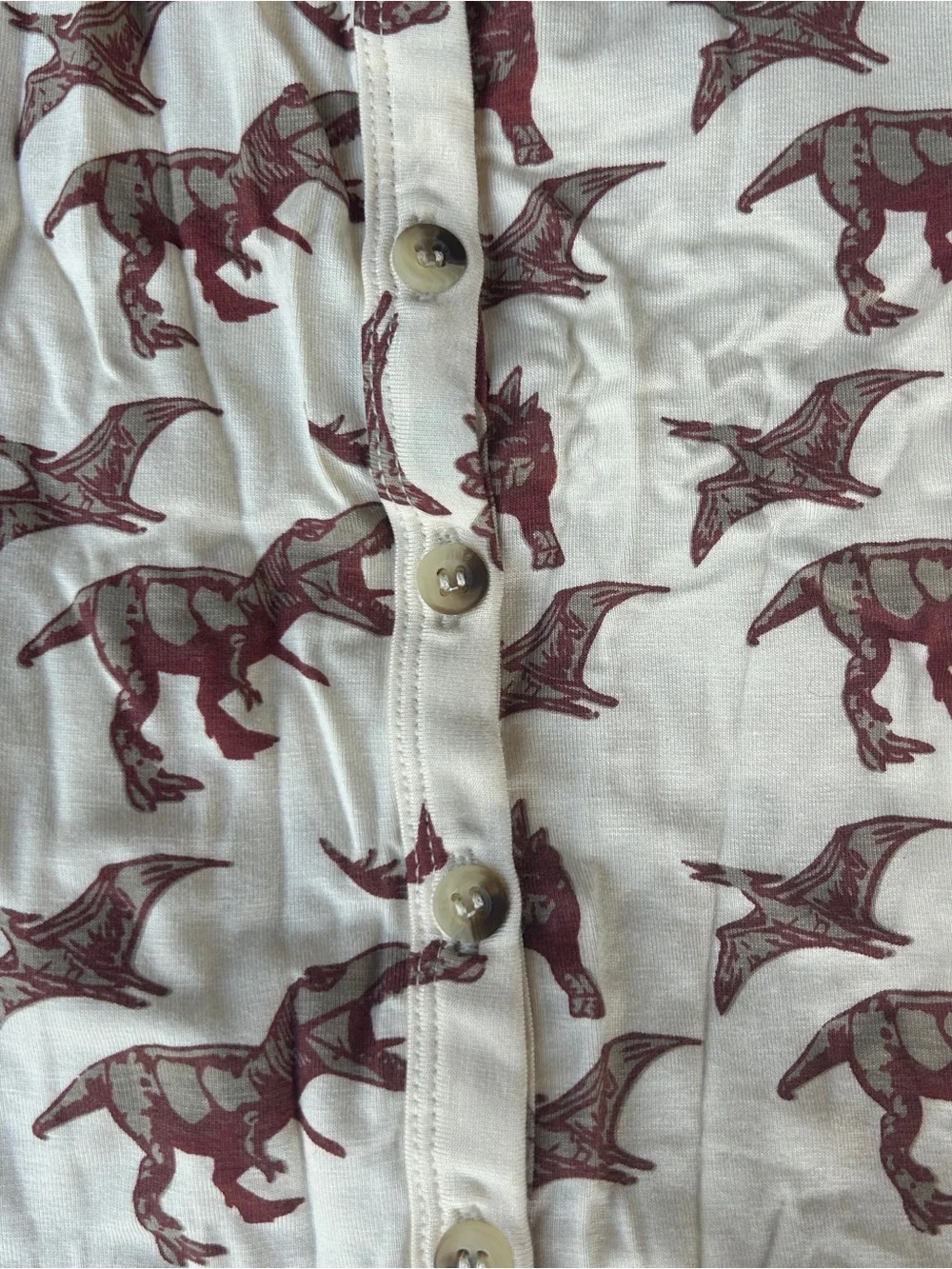 Kate Quinn cream sleeveless dinosaur romper